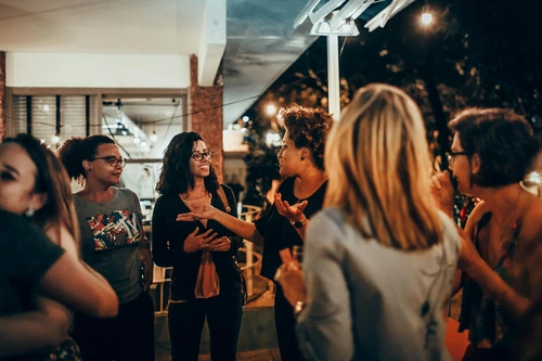 Group of women chatting outdoors at night