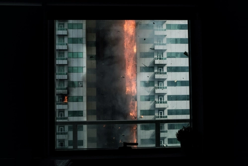 High‑rise building on fire seen through window